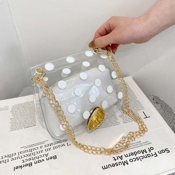 Γυναικεία διαφανής τσάντα ώμου με μεταλλική λαβή