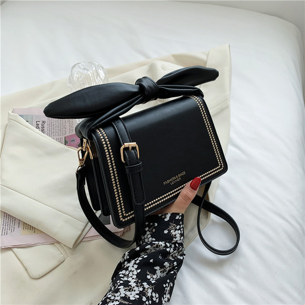 Γυναικεία τσάντα με αγκράφα και δερμάτινη κορδέλα