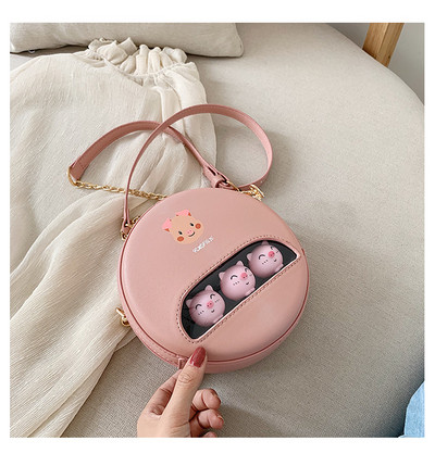 Moderna apaļa soma ar aplikāciju un garu rokturi