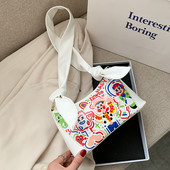 Μικρή γυναικεία τσάντα σε λευκό και μαύρο χρώμα με πολύχρωμη διακόσμηση