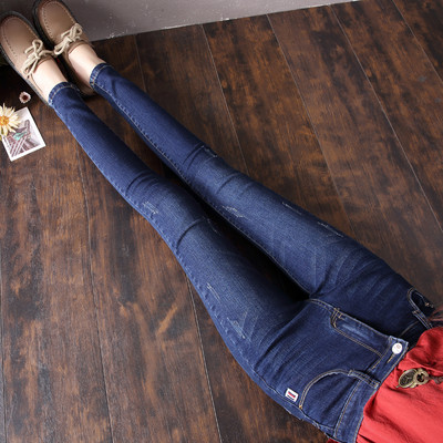 Sieviešu džinsi ar augstu vidukli un emblēmu kabatā