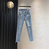 Sieviešu džinsi ar saplēstu motīvu un pogām zilā krāsā