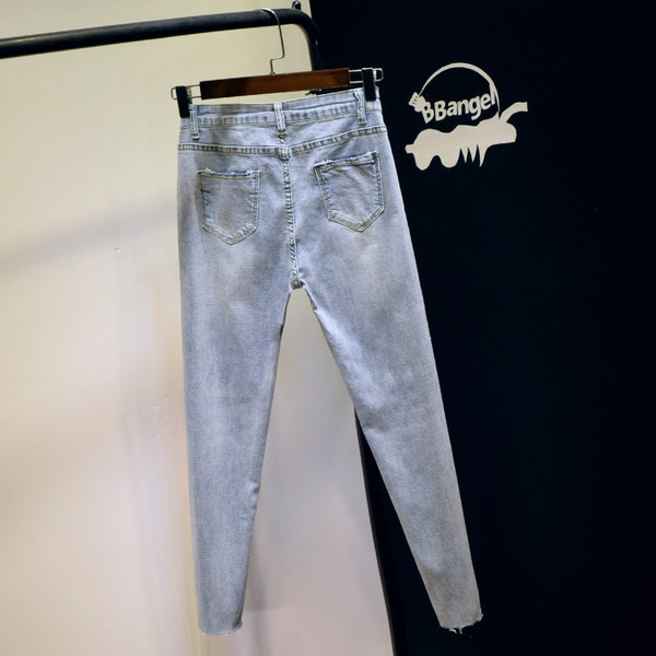 Sieviešu džinsi ar augstu vidukli un plēstiem motīviem - zilā krāsā