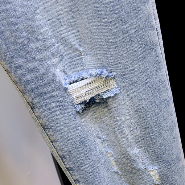 Sieviešu džinsi ar augstu vidukli un plēstiem motīviem - zilā krāsā