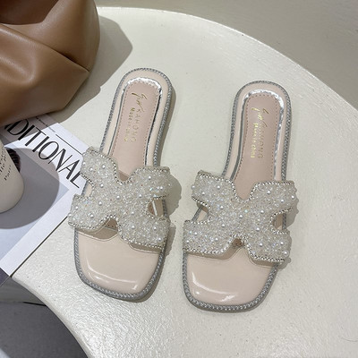 Sieviešu čības ar plakanu zoli, kas dekorēts ar pērlēm