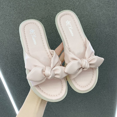 Γυναικείες παντόφλες με επίπεδη σόλα και κορδέλα