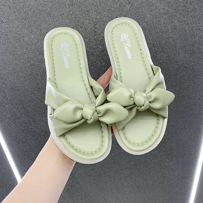 Γυναικείες παντόφλες με επίπεδη σόλα και κορδέλα