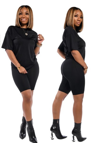 Običan model ženskog kompleta sa širokom majicom i tajicama na bodi