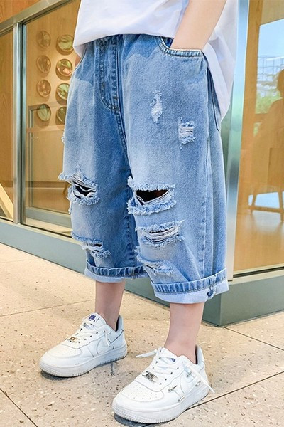 Детски дънкови панталони с разкъсан десен в син цвят 