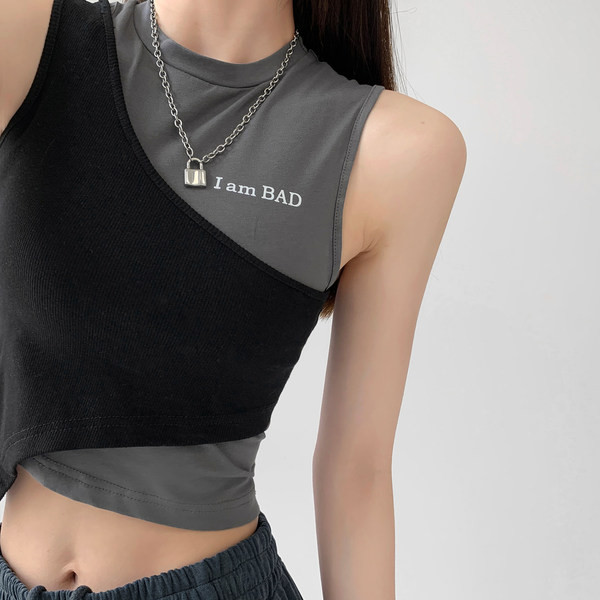 Asümmeetriline naiste topp tikandi ja ümara kaelusega