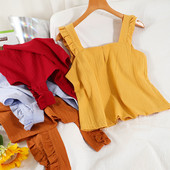 Ühevärviline naiste topp, mille rihmadel on lokid