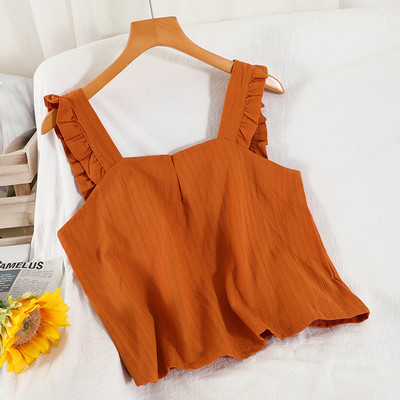 Ühevärviline naiste topp, mille rihmadel on lokid