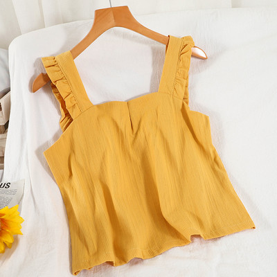 Ühevärviline naiste topp, mille rihmadel on lokid