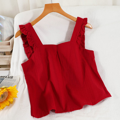 Ühevärviline naiste topp, mille rihmadel on lokid