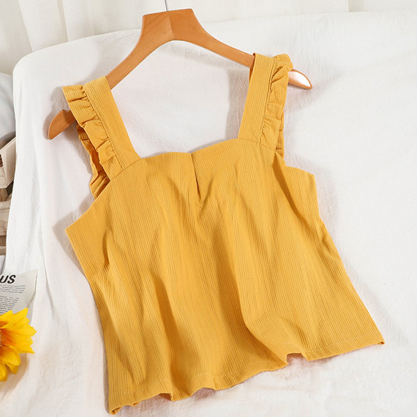 Ühevärviline naiste topp, mille rihmadel on lokid