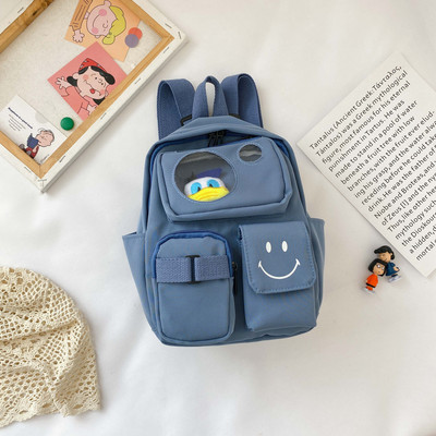 Kaasaegne taskute ja lühikese sangaga laste seljakott