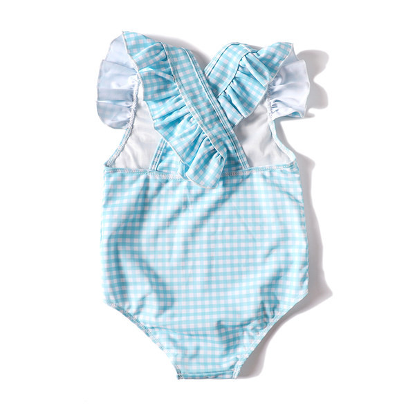 Laste ujumistrikoo seljas ristrihmadega ja lokkidega