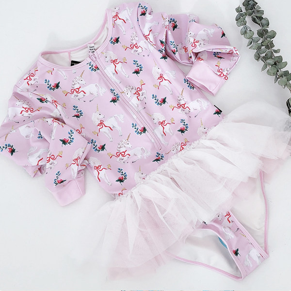 Laste ujumistrikoo pikkade varrukatega ja pitsaseelikuga