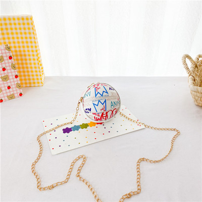 Moderna dječja okrugla mini torba s dugom metalnom ručkom