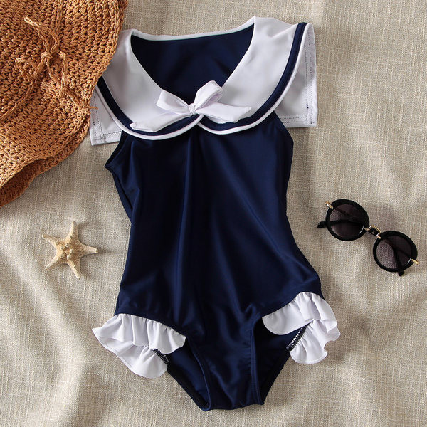 Laste täisujumistrikoo paela ja lokkidega