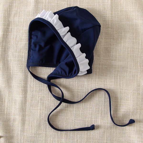 Laste täisujumistrikoo paela ja lokkidega