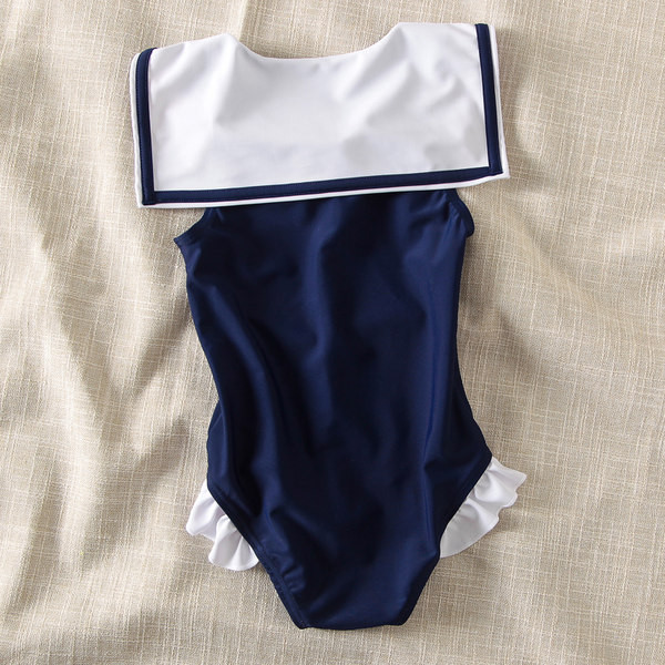 Laste täisujumistrikoo paela ja lokkidega