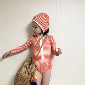 Ruuduline lukuga ja pikkade varrukatega ujumistrikoo