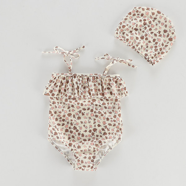 Terve peenikeste rihmade ja lokkidega laste ujumistrikoo