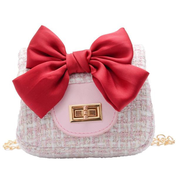 Elegantna dječja torba s dugom metalnom ručkom i vrpcom