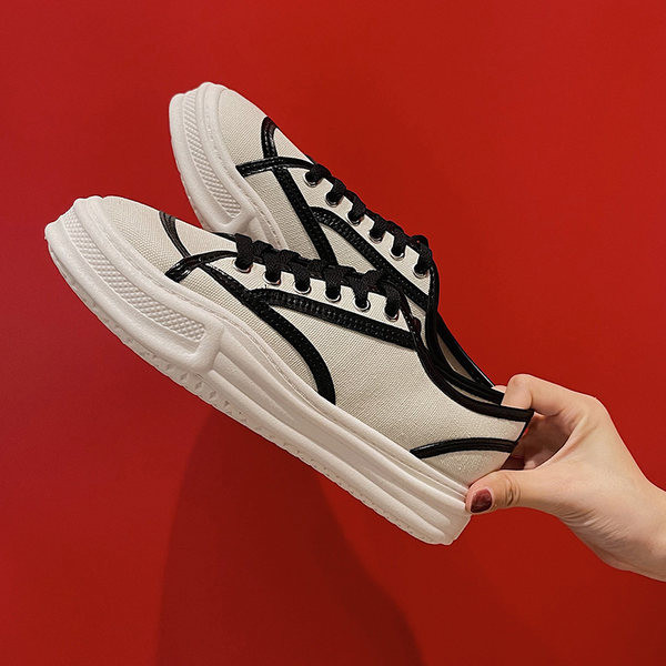 Naiste valged ja mustad tossud paelte ja lameda tallaga