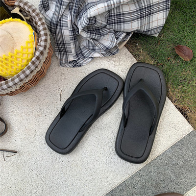 Sieviešu gumijas flip-flops virs pludmales