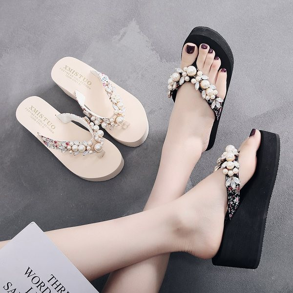 Sieviešu čības pāri purngalam uz augstas platformas, kas dekorētas ar pērlēm un akmeņiem