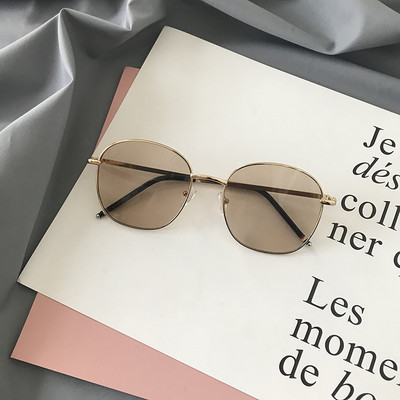 Modernas sieviešu brilles ar apaļu formu un plāniem metāla rāmjiem