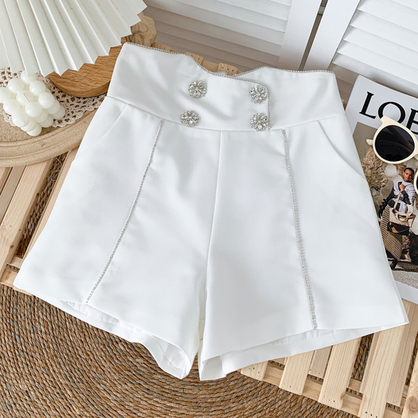 Jauns sieviešu šortu modelis ar pogām baltā un melnā krāsā