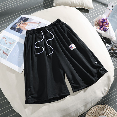 Sieviešu sporta bikses ar saitēm un pogām 3/4 garumā