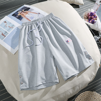 Sieviešu sporta bikses ar saitēm un pogām 3/4 garumā