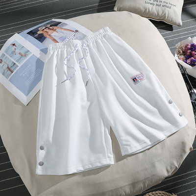 Sieviešu sporta bikses ar saitēm un pogām 3/4 garumā