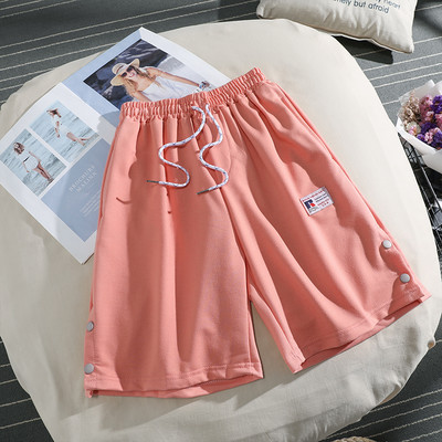 Sieviešu sporta bikses ar saitēm un pogām 3/4 garumā