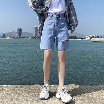 Sieviešu džinsi ar saplēstām tiesībām zilā krāsā