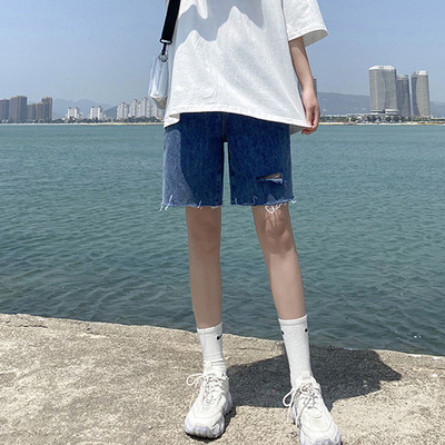 Sieviešu džinsi ar saplēstām tiesībām zilā krāsā