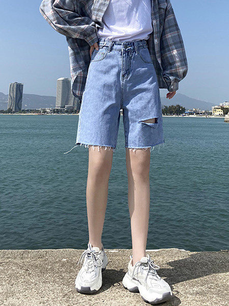 Sieviešu džinsi ar saplēstām tiesībām zilā krāsā