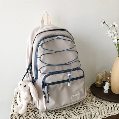 Sieviešu mugursoma ar šņorēm un priekšējo kabatu vairākās krāsās