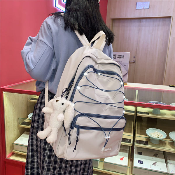 Sieviešu mugursoma ar šņorēm un priekšējo kabatu vairākās krāsās