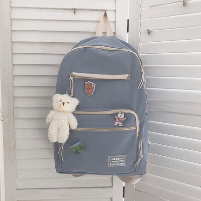 Vienkrāsaina sieviešu mugursoma ar aksesuāru un priekšējo kabatu