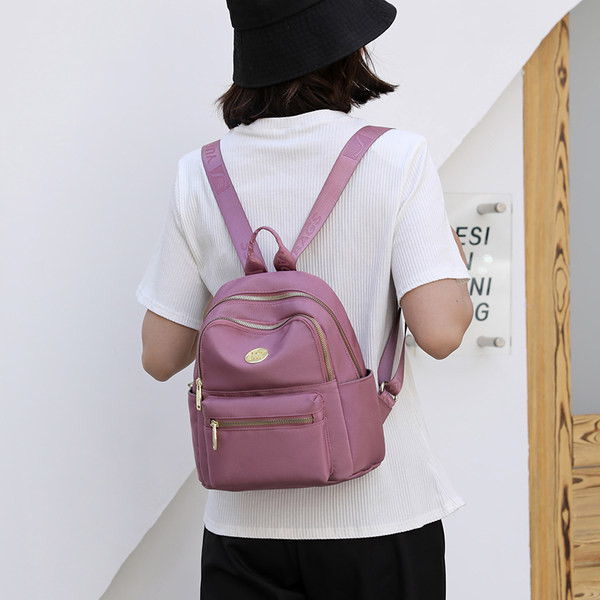 Jauna modeļa maza tekstila mugursoma ar metāla emblēmu