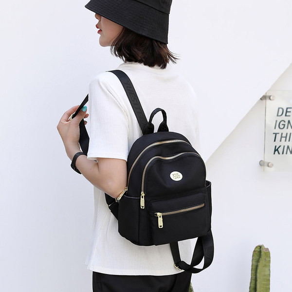 Jauna modeļa maza tekstila mugursoma ar metāla emblēmu