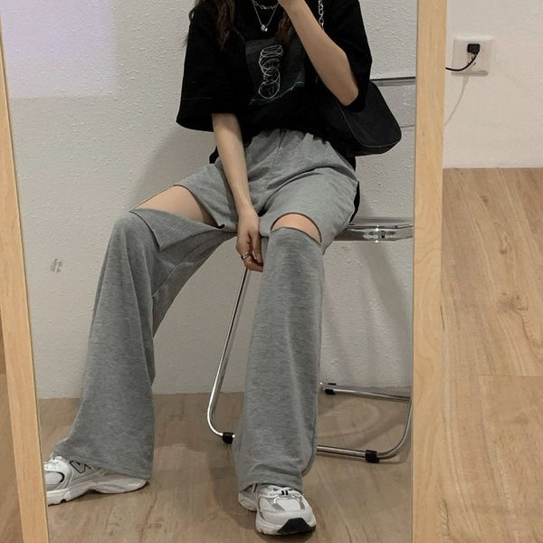 Sieviešu bikšu plats modelis ar saplēstiem motīviem