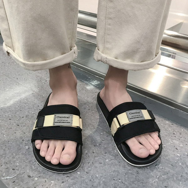 Vīriešu tekstila čības ar emblēmu un plakanu zoli