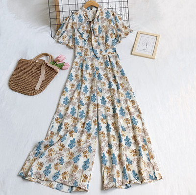 Garš sieviešu kombinezons ar ziedu motīviem un rāvējslēdzēju