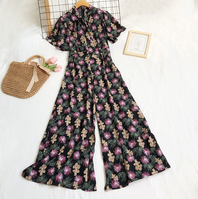 Garš sieviešu kombinezons ar ziedu motīviem un rāvējslēdzēju